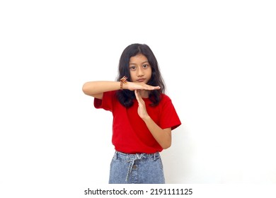 Asian Little Girl Standing While Making Time Out Hand Gesture. Isolated On White Background