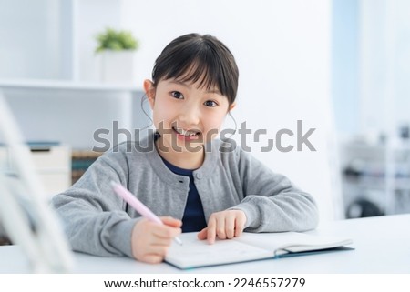 Asian little girl studying in the room.