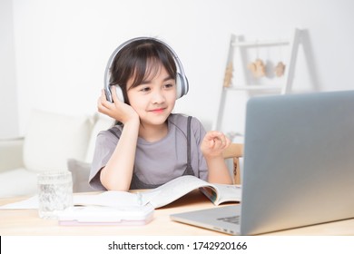 Asian Little Girl Surfing Internet At Home