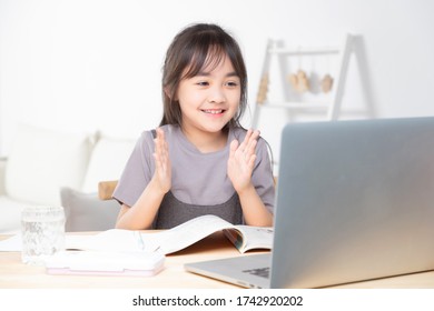 Asian Little Girl Surfing Internet At Home