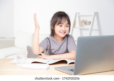 Asian Little Girl Surfing Internet At Home