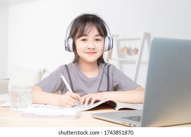 Asian Little Girl Surfing Internet At Home