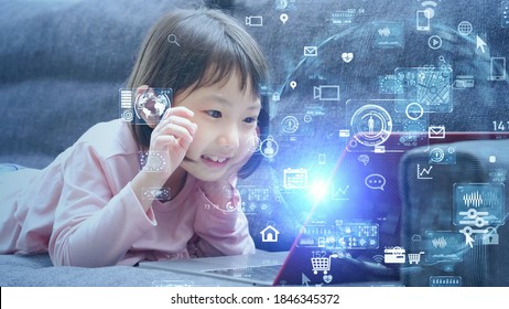 Asian little girl using laptop PC. Education technology. EdTech.