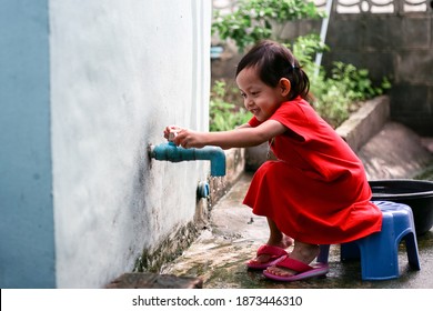 Asian little girl washing hands and close at home