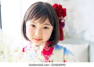 Asian little girl wearing kimono. Japanese traditional clothes. Memorial photo.