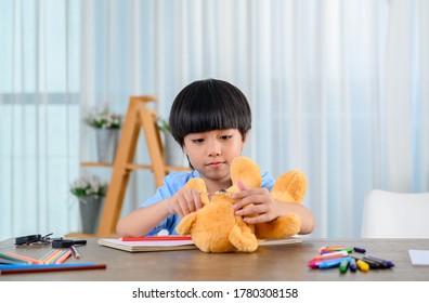 Asian Little Kid Alone At Home And Play With Doll. Son With Toy As Friend. Lonely Boy Unhappy.