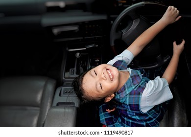 Asian Little Young Girl Smiling And Sitting In The Car With Steering Wheel.Happiness Of Cute Kid In Student Uniform On Car Sunroof Top View.Holiday,Vacation,Family,Travel Concept.