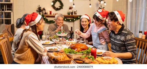 Asian lovely family celebrating Christmas party together in house. Attractive parents and relatives having dinner eating foods to celebrate holiday Thanksgiving, X-mas eve on dining table at home.
 - Powered by Shutterstock