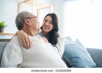 Asian Lovely Family, Young Daughter Greeting And Hugging Older Father. Attractive Woman Granddaughter Visit Senior Elder Mature Man In House Enjoy Spend Leisure Time Together In Living Room And Smile.