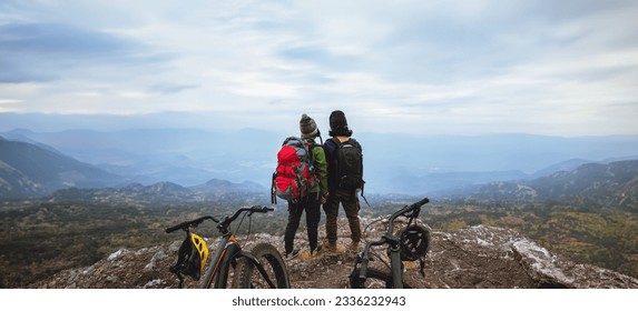  Asian lover woman and man Travel Nature. Travel relax ride a bike Wilderness in the wild. Standing on a rocky cliff. - Powered by Shutterstock