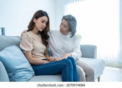 Asian Loving Elderly Mother Comforts Upset Daughter Crying For Problem. Caring Senior Older Mom Support, Consoling And Understand Empathy To Stressed Young Woman In Tears At Home. Family Relationship.