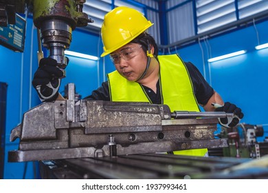 Asian Machinist In Safety Suit Operating The Professional Lathes In Metalworking Factory, Lathe Grinding Metalworking Industry Concept