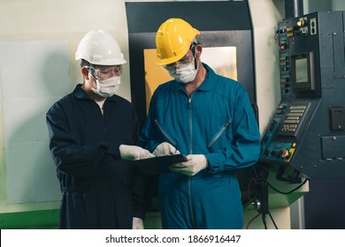 Asian maintenance worker in uniform wear helmet and protective face mask checking machine in factory. Concept of new normal work after Covid-19 Coronavirus outbreak - Shutterstock ID 1866916447