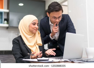 Asian Malay Executive Working At Home With Laptop Discussing