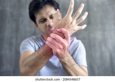 Asian Male Arm Holding Wrist Pain Syndrome, Arthritis, Hand Numbness, Office Syndrome Concept.