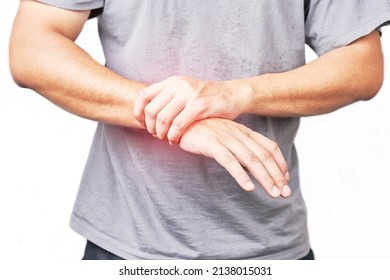 Asian male arms holding his painful wrist caused by exercise. Asian man hand holding his pain wrist isolated on background                        