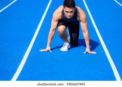 Asian Male  Athlete On  Race Track Is Ready To Run