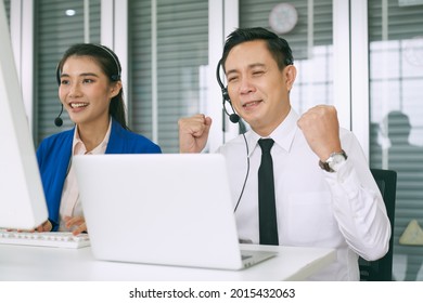 Asian Male Call Center Use Sign Language To Support Customer In Laptop And Team Suport By Voice In Office, Helpdesk Solution Concept