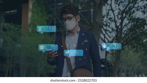 Asian male chef or restaurant owner checking smartphone. He wears glasses, mask, and casual suit - Powered by Shutterstock