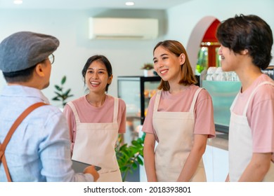 Asian Male Coffee Shop Manager Briefing Man And Woman Staff Team Before Working. Small Business Cafe And Restaurant Owner Instruct Part Time Employee Preparing Service To Customers Before Opening