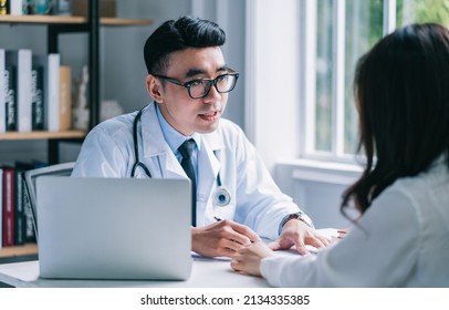 Asian Male Doctor Examining Patient At Clinic