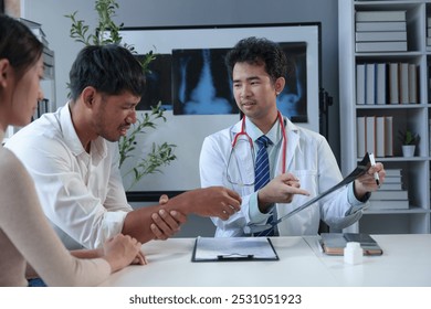 Asian male doctor explaining bone x-ray examination film to patient Radiography of the arm bones joint bones in the body treatment concept Diagnosis. - Powered by Shutterstock