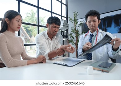 Asian male doctor explaining bone x-ray examination film to patient Radiographs of the arm bones, joints, and spine body organs treatment concept Diagnosis. - Powered by Shutterstock