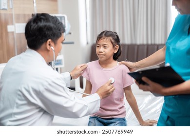 Asian male doctor and a female nurse gently examine a young girl in the hospital, ensuring her comfort and care throughout the process. - Powered by Shutterstock