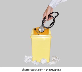 Asian Male Doctor Or Medical Student. He Discard The Black Stethoscope Into The Plastic Trash Can. It Means He Quit Medical Profession Or No Longer Want To Be Doctor. Absconding And Resigning.