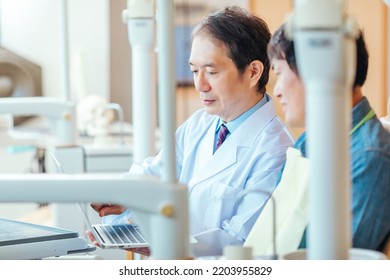 Asian Male Doctor And Patient (dentist)