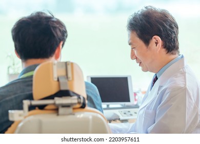 Asian Male Doctor And Patient (dentist)