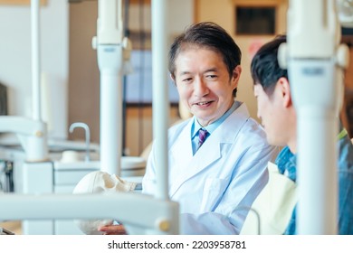 Asian Male Doctor And Patient (dentist)