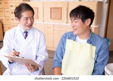 Asian Male Doctor And Patient (dentist)