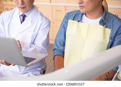 Asian Male Doctor And Patient (dentist)