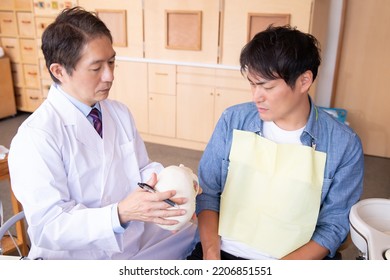 Asian Male Doctor And Patient (dentist)