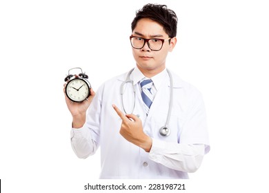 Asian Male Doctor With Serious Face  Point To A Clock  Isolated On White Background