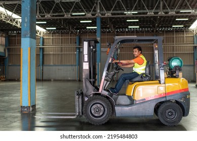 Asian Male Driver Driving Forklift To Shipping Delivery Product In The Warehouse Distribution. Import Export Logistic Career, Worker Working At Industrial Factory.