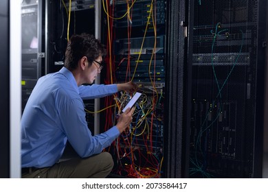 Asian male engineer using digital tablet and inspecting computer server in computer server room. database server management and maintenance concept - Powered by Shutterstock