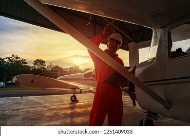 Asian male engineers were checking the availability of aircraft - Powered by Shutterstock