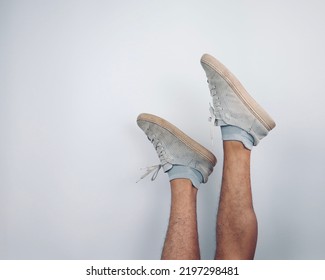 Asian Male Feet Wearing Old White Sneakers  Isolated Over White Background                    