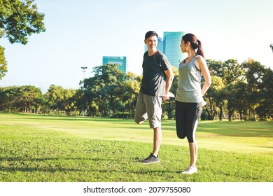 Asian Male And Female Couple Exercise In The Outdoor Park In The Morning. They Are Healthy, Smiling And Happy. Fitness Concept, Health Care