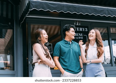 Asian Male and Female Friends Bonding on the Street in Front of Cozy Cafe. Young Adult Friends Talking and Having a Good Time Together. Youthful Urban Lifestyle Concept - Shutterstock ID 2337228853