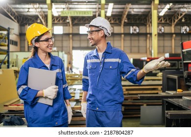 Asian Male And Female Industrial Worker Working In Manufacturing Plant. Attractive Industry Factory Engineer People Wear Helmet And Processes Orders And Product At Manufactory Warehouse With Happiness