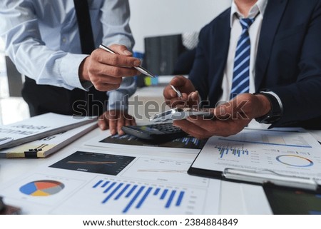 Asian male financial officer or accountant checking investment results Financial budget analysis Planning to summarize results and report to the meeting Audit concept and investment results.