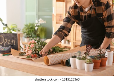 Asian Male Florist Working In Shop