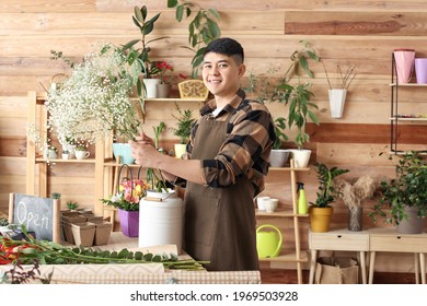 Asian Male Florist Working In Shop