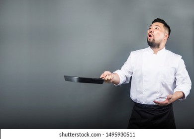 An Asian Male Chef，Chef Holding A Wok In His Hand