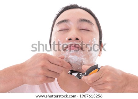 Asian male model shave his beard with razorblade isolated on white background
