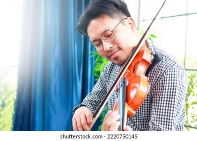 Asian Male Musicians Enjoy Playing The Violin. Classical Stringed Instruments. Bands And Live Music Performances. Classical Music Teacher