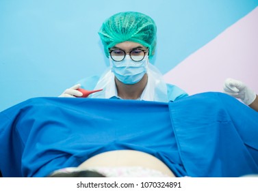 Asian male obstetrician and scrubs nurse are delivered to the pregnant woman in the delivery room of the hospital,A team of doctors and nurses ready to deliver in labor room,Health care professionals, - Powered by Shutterstock